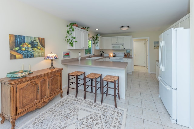 4980 Doral Dr, Ann Arbor, MI 48108 - kitchen with white appliances, a sink, a peninsula, a kitchen breakfast bar, and light tile patterned flooring