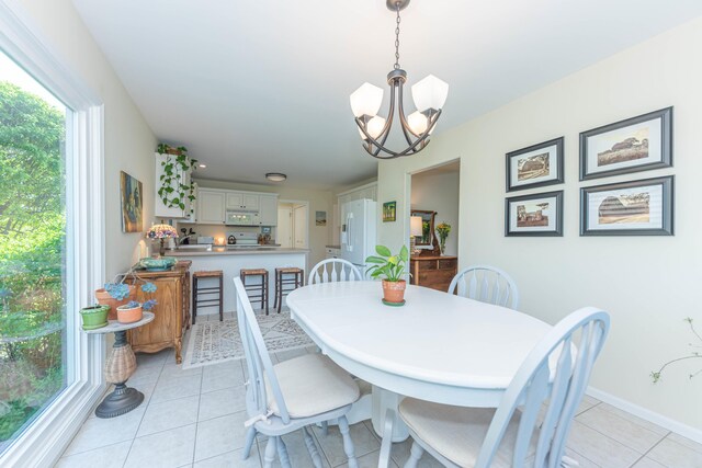 4980 Doral Dr, Ann Arbor, MI 48108 - dining space with plenty of natural light, a chandelier, light tile patterned flooring, and baseboards