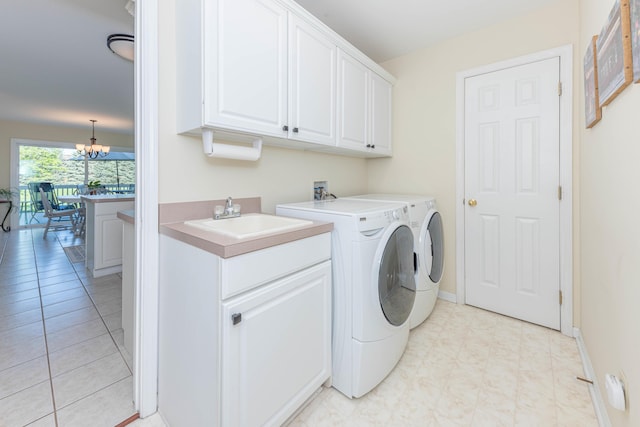 4980 Doral Dr, Ann Arbor, MI 48108 - laundry room featuring cabinet space, washing machine and clothes dryer, a chandelier, and baseboards