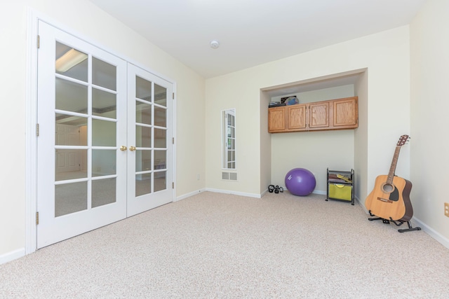 4980 Doral Dr, Ann Arbor, MI 48108 - workout room featuring french doors, carpet floors, and baseboards