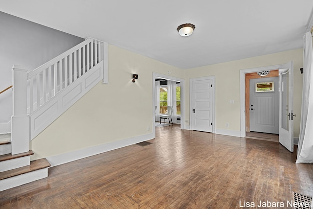 205 N Franklin St, Greenville, MI 48838 - foyer with stairway, wood finished floors, and baseboards