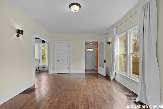 205 N Franklin St, Greenville, MI 48838 - unfurnished room featuring wood finished floors and baseboards