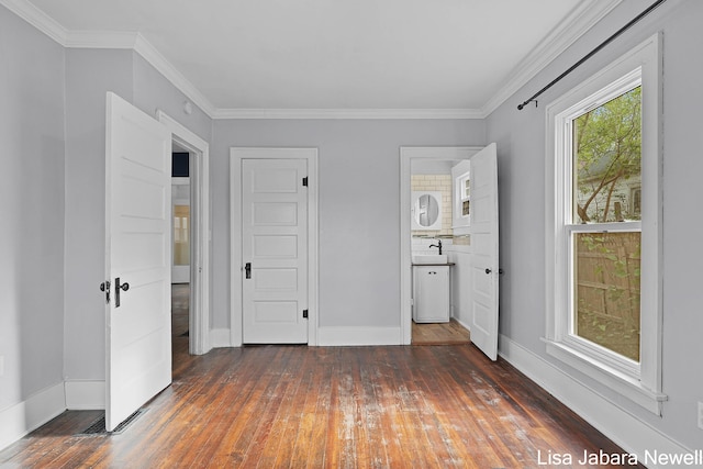 205 N Franklin St, Greenville, MI 48838 - unfurnished bedroom featuring hardwood / wood-style flooring, baseboards, crown molding, ensuite bathroom, and a sink