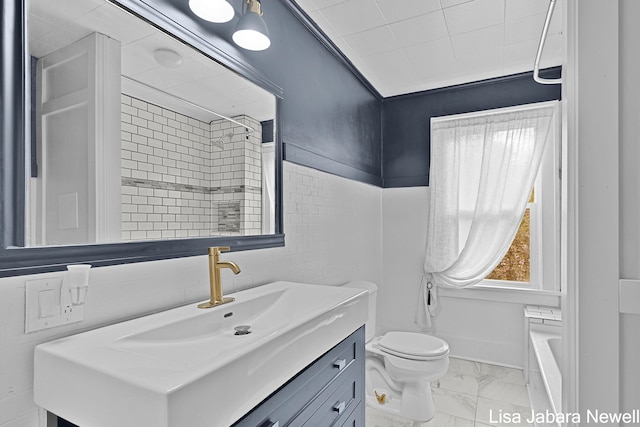 205 N Franklin St, Greenville, MI 48838 - full bath featuring marble look tiles, toilet, vanity, a shower, and tile walls