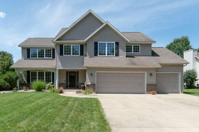 9908 Mariner St, Portage, MI 49002 - view of front facade featuring concrete driveway, a front yard, and brick siding