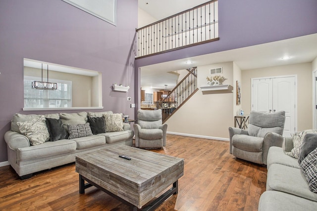 9908 Mariner St, Portage, MI 49002 - living area featuring stairway, a high ceiling, wood finished floors, and baseboards
