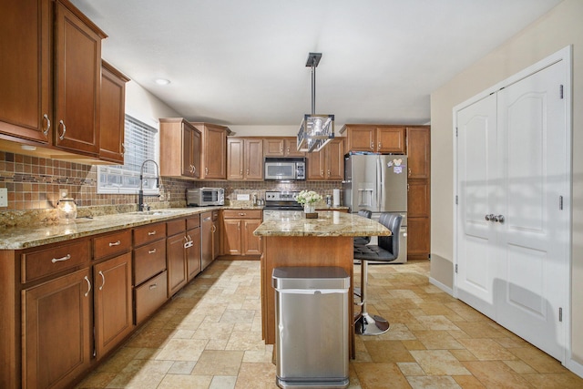 9908 Mariner St, Portage, MI 49002 - kitchen with stainless steel appliances, stone tile flooring, decorative backsplash, a breakfast bar area, and light stone counters