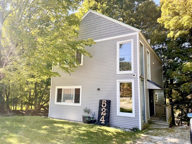 524 S Mears Ave, Whitehall, MI 49461 - rear view of property with a lawn and view of scattered trees