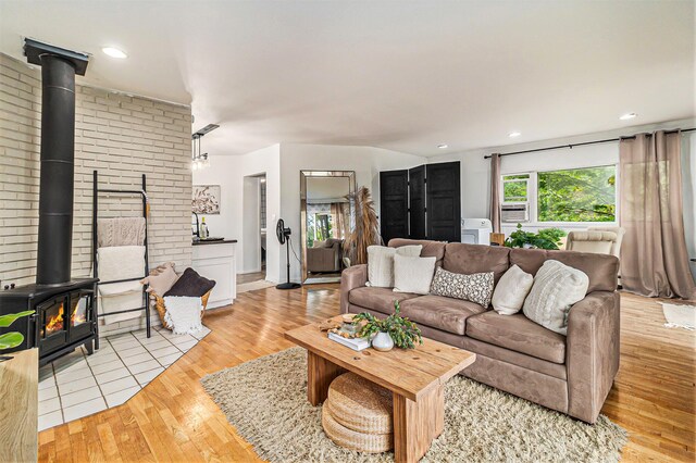 524 S Mears Ave, Whitehall, MI 49461 - living room featuring a wood stove, light wood-type flooring, and recessed lighting