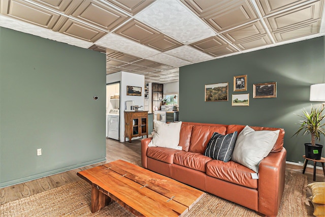 524 S Mears Ave, Whitehall, MI 49461 - living area featuring an ornate ceiling, washer / clothes dryer, wood finished floors, and baseboards