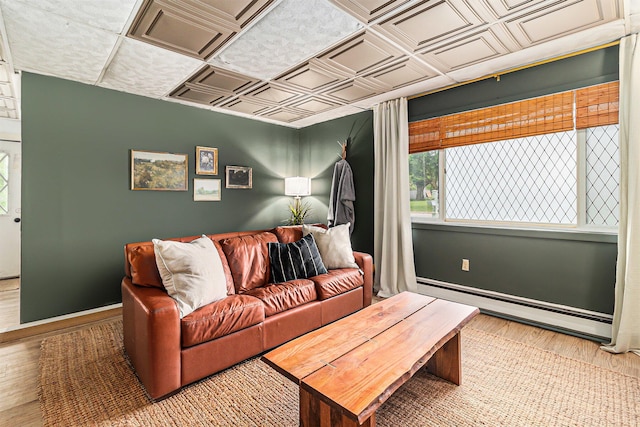 524 S Mears Ave, Whitehall, MI 49461 - living room with an ornate ceiling, baseboard heating, wood finished floors, and baseboards