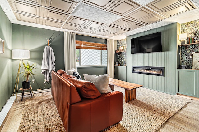 524 S Mears Ave, Whitehall, MI 49461 - living area featuring an ornate ceiling, wood finished floors, a glass covered fireplace, and baseboards