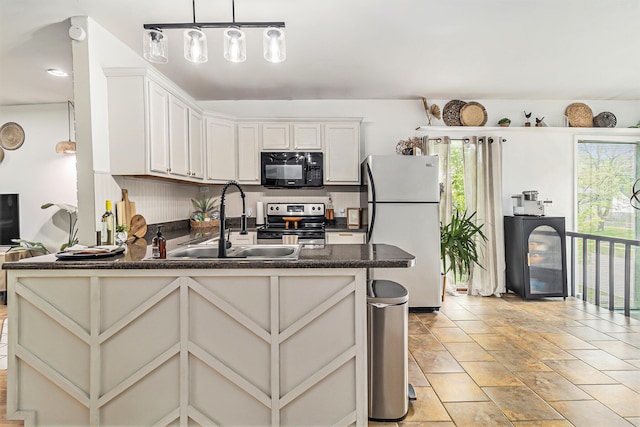 524 S Mears Ave, Whitehall, MI 49461 - kitchen featuring freestanding refrigerator, electric stove, black microwave, a sink, and plenty of natural light
