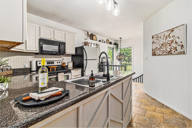 524 S Mears Ave, Whitehall, MI 49461 - kitchen featuring black microwave, electric range, a sink, stone finish flooring, and freestanding refrigerator