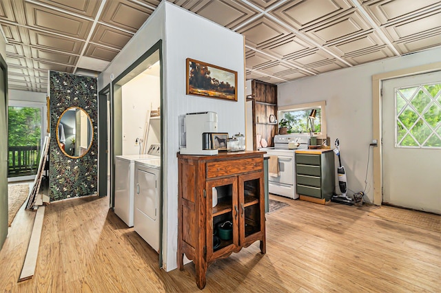 524 S Mears Ave, Whitehall, MI 49461 - washroom featuring an ornate ceiling, independent washer and dryer, healthy amount of natural light, and light wood finished floors