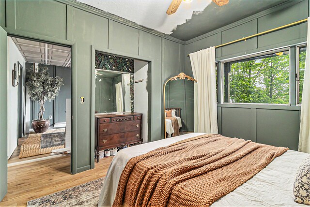 524 S Mears Ave, Whitehall, MI 49461 - bedroom featuring wood finished floors, a decorative wall, and ceiling fan