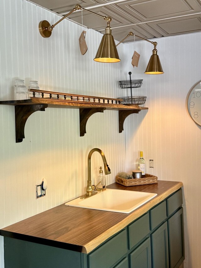 524 S Mears Ave, Whitehall, MI 49461 - kitchen with green cabinetry, a sink, butcher block counters, open shelves, and wood walls