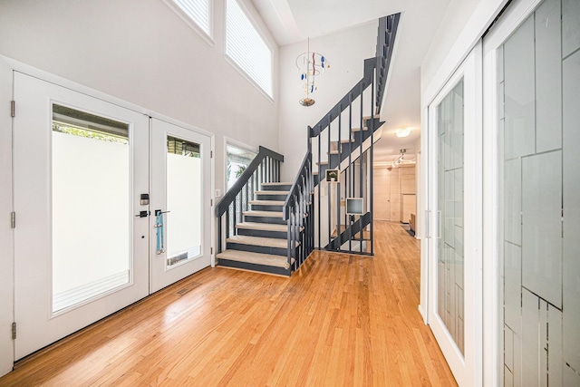 1410 N Folkstone Ct, Ann Arbor, MI 48105 - foyer entrance with wood finished floors, stairs, healthy amount of natural light, and a towering ceiling