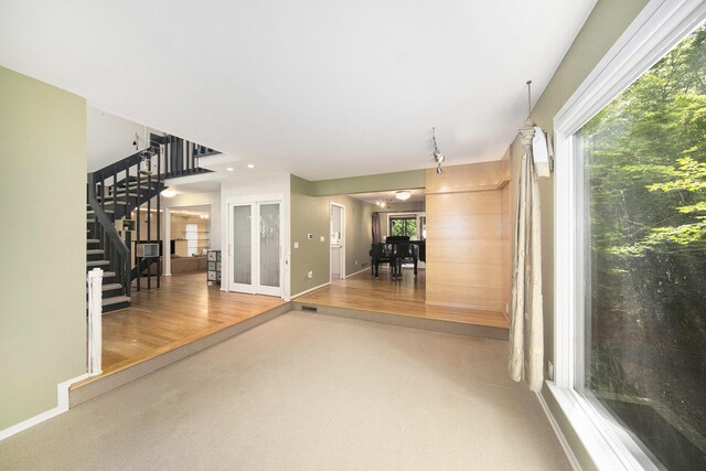 1410 N Folkstone Ct, Ann Arbor, MI 48105 - interior space featuring stairs, carpet floors, baseboards, and healthy amount of natural light