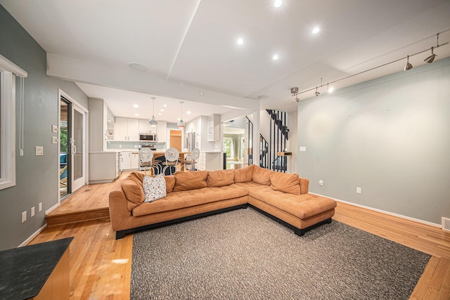 1410 N Folkstone Ct, Ann Arbor, MI 48105 - living room with light wood-style floors, stairway, baseboards, and recessed lighting