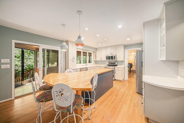 1410 N Folkstone Ct, Ann Arbor, MI 48105 - dining room with healthy amount of natural light, light wood-type flooring, and recessed lighting