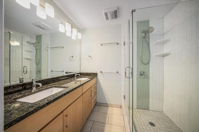 1410 N Folkstone Ct, Ann Arbor, MI 48105 - bathroom with a stall shower, double vanity, and tile patterned floors