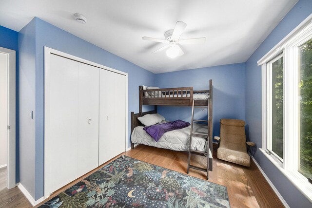 1410 N Folkstone Ct, Ann Arbor, MI 48105 - bedroom with wood finished floors, baseboards, a closet, and ceiling fan