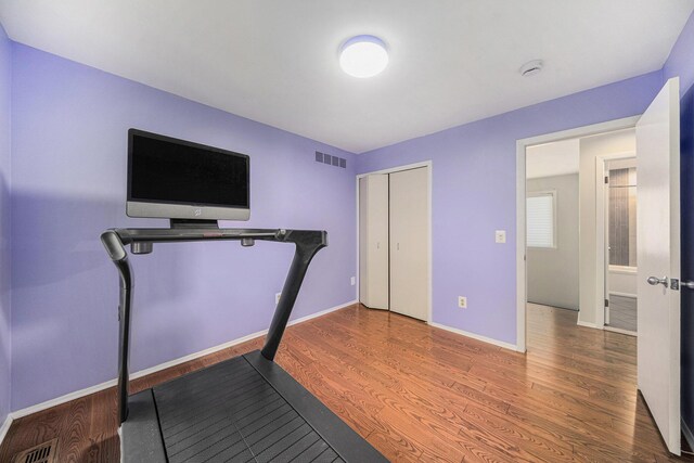 1410 N Folkstone Ct, Ann Arbor, MI 48105 - exercise area featuring wood finished floors and baseboards