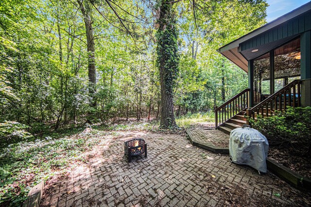 1410 N Folkstone Ct, Ann Arbor, MI 48105 - view of patio featuring a fire pit and stairs