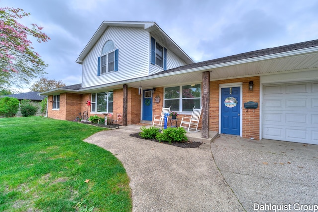 traditional home featuring a porch, brick siding, driveway, and a front yard