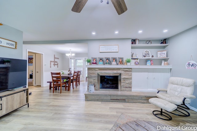 living room featuring ceiling fan, light wood-type flooring, a chandelier, and recessed lighting
