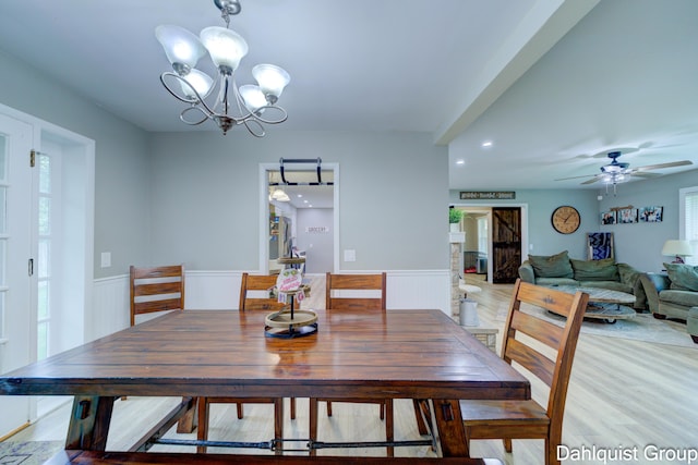 dining space featuring a chandelier, a wainscoted wall, light wood finished floors, a ceiling fan, and recessed lighting