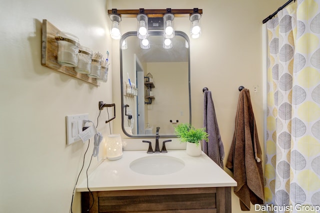 bathroom featuring vanity and a shower with shower curtain