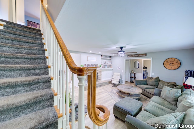 living area with wood finished floors, stairs, ceiling fan, and recessed lighting