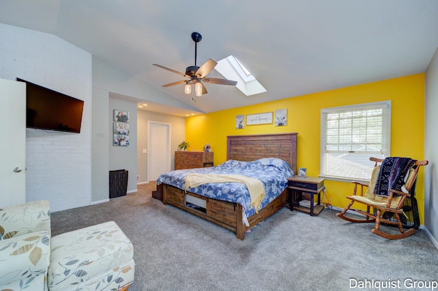 carpeted bedroom with vaulted ceiling, a skylight, baseboards, and ceiling fan