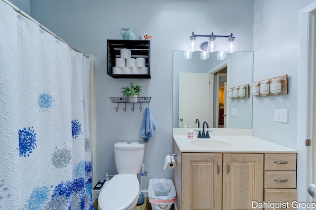 bathroom with vanity, toilet, and curtained shower