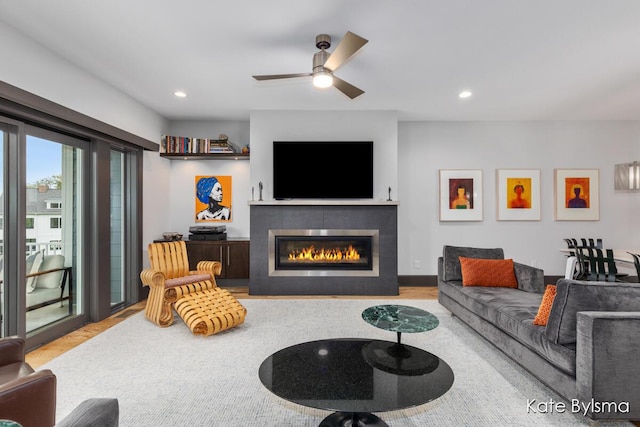 657 Greenslate Dr SE, Ada, MI 49301 - living room with wood finished floors, a fireplace, ceiling fan, and recessed lighting