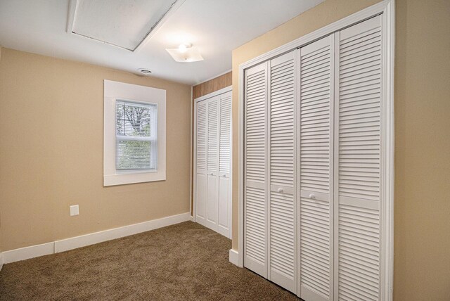 2335 Holmes Rd, Ypsilanti, MI 48198 - unfurnished bedroom featuring dark carpet, baseboards, and a closet