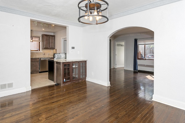 18106 Roselawn St, Detroit, MI 48221 - unfurnished dining area featuring arched walkways, a chandelier, dark wood finished floors, baseboards, and ornamental molding