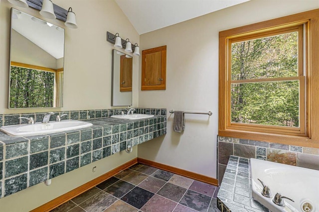 6800 Harbert Rd, Harbert, MI 49115 - full bath with baseboards, lofted ceiling, a whirlpool tub, a sink, and stone finish flooring