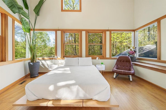 6800 Harbert Rd, Harbert, MI 49115 - bedroom with wood finished floors, baseboards, and a towering ceiling