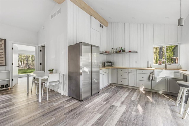 6800 Harbert Rd, Harbert, MI 49115 - kitchen with freestanding refrigerator, high vaulted ceiling, light wood finished floors, gray cabinetry, and plenty of natural light