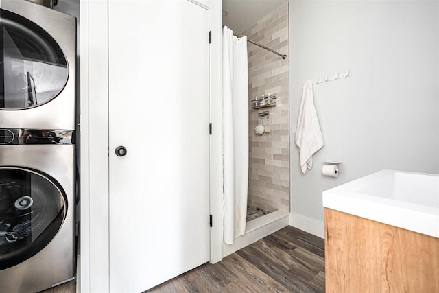 6800 Harbert Rd, Harbert, MI 49115 - full bathroom with estacked washer and dryer, a shower stall, wood finished floors, vanity, and baseboards
