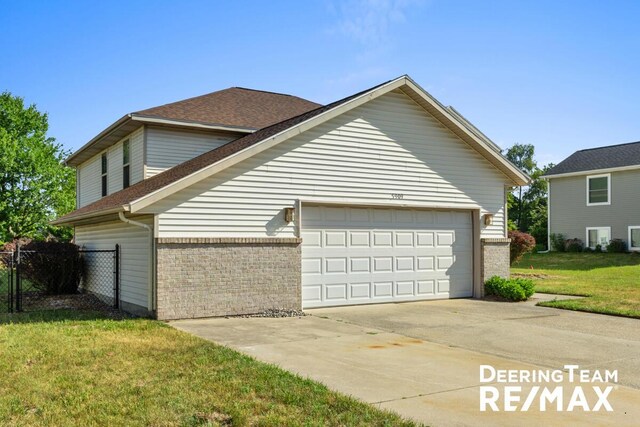 5909 Maple Bend Trl, Allendale, MI 49401 - view of side of property featuring brick siding, a shingled roof, a garage, and driveway