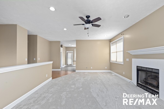 5909 Maple Bend Trl, Allendale, MI 49401 - unfurnished living room with carpet, ceiling fan, a tile fireplace, and recessed lighting