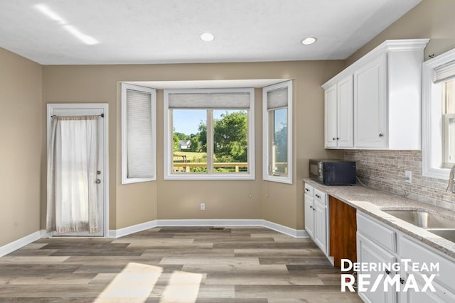 5909 Maple Bend Trl, Allendale, MI 49401 - kitchen with black microwave, white cabinetry, healthy amount of natural light, light wood-type flooring, and recessed lighting