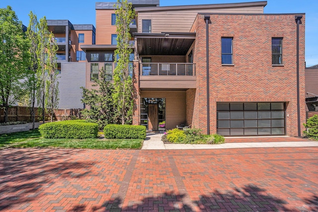 26 W 6th St, Holland, MI 49423 - view of building exterior with a garage, decorative driveway, and fence