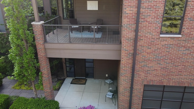 26 W 6th St, Holland, MI 49423 - back of house with brick siding and a balcony