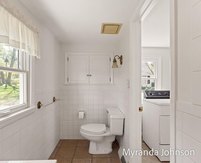15926 Beach Dr, Spring Lake, MI 49456 - half bath featuring washer / dryer, toilet, tile walls, tile patterned flooring, and wainscoting
