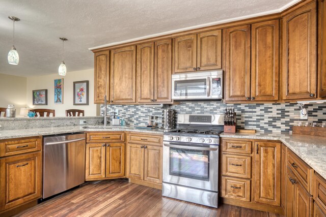 108 Eastbrook Ave, Houghton Lake, MI 48629 - kitchen featuring stainless steel appliances, a textured ceiling, brown cabinets, dark wood finished floors, and a sink